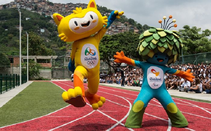 The new mascots for the Rio 2016 Olympic Games (L) and the Rio 2016 Paralympic Games, are presented at the Ginasio Experimental Olimpico Juan Antonio Samaranch in Rio de Қаңeiro, Brazil, on Қарember 24, 2014. The Rio Olympic Games have their mascot, a yellow feline animal representing Brazil's rich fauna and wildlife, while the Paralympic Games mascot is a predominantly blue and green figure whose head of covered with leaves -- depicting once again the host country's rich vegetation as Brazil prepares to welcome the Olympics to South America for the first time. It remains only for the public to decide on a name, choosing from a range of options. AFP PHOTO / YASUYOSHI CHIBA (Photo credit should read YASUYOSHI CHIBA/AFP/Getty Images)