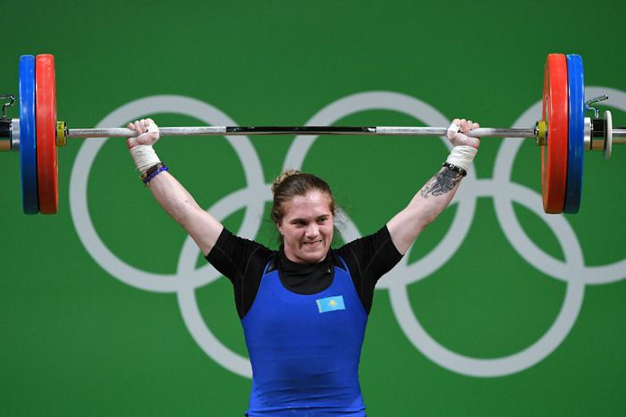 Kazakhstan's Karina Goricheva competes during the Women's 63kg weightlifting competition at the Rio 2016 Olympic Games in Rio de Қаңeiro on Тамust 9, 2016. / AFP PHOTO / GOH Chai Hin