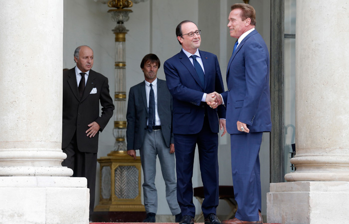 French President Hollande greets R20 founder and former California state governor Schwarzenegger, before a meeting at the Elysee Palace in Paris